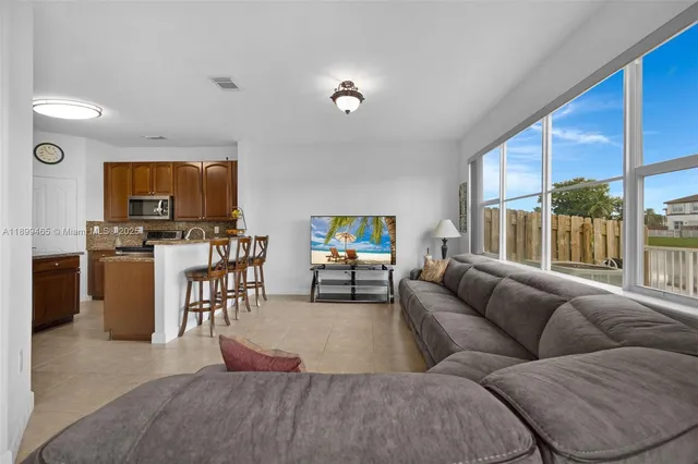 a living room with furniture and a large window