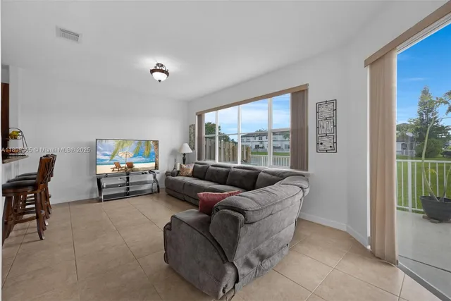 a living room with furniture and a large window