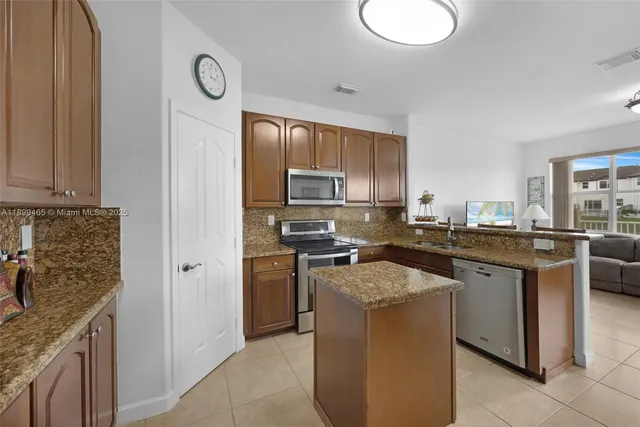a kitchen with a sink and refrigerator