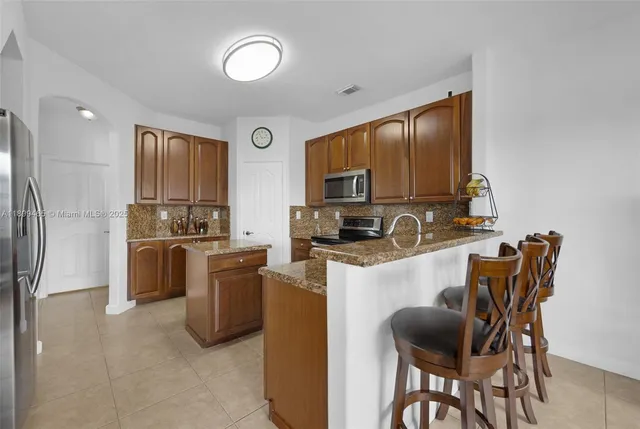 a view of a porch with chairs and potted plants