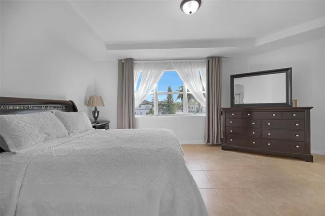 a bedroom with a bed and a dresser in it