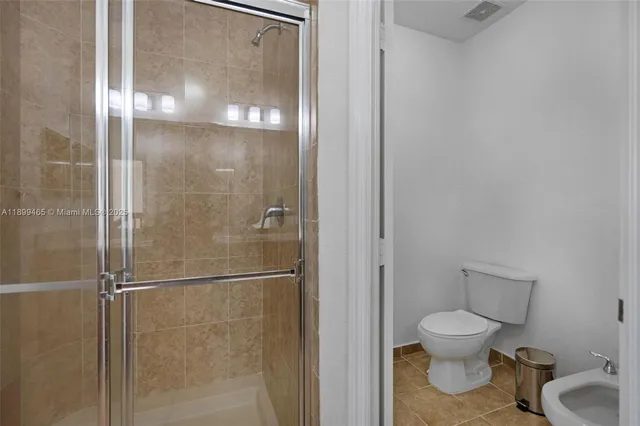 a bedroom with a bed and a lamp