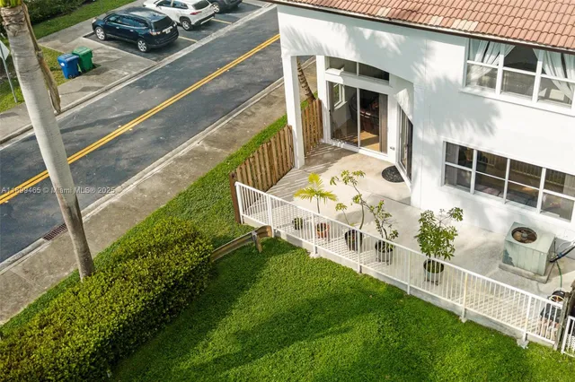 an aerial view of residential houses with outdoor space and swimming pool
