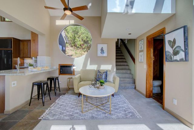 a living room with furniture and a potted plant