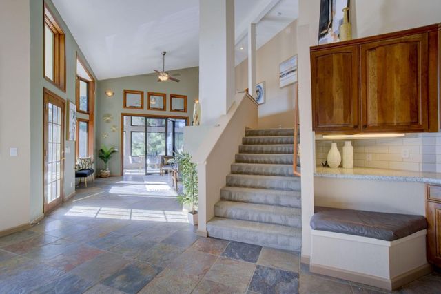 a view of a living room filled with furniture and a large window