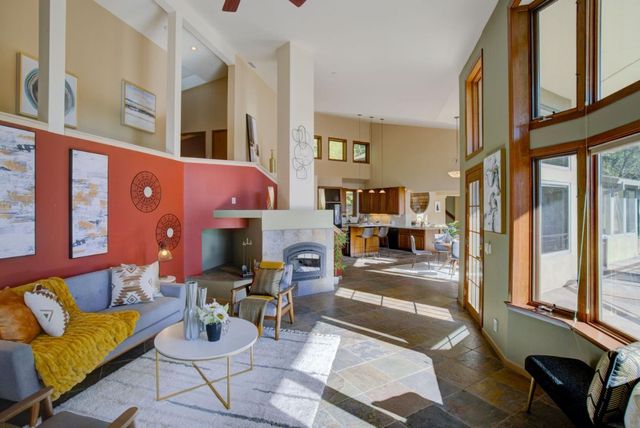 a living room with furniture and a chandelier