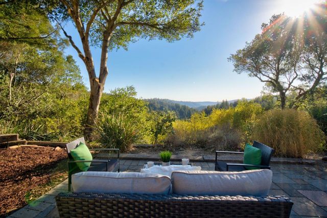 a view of a house with backyard and deck