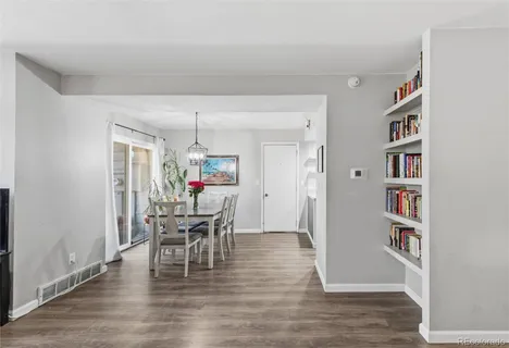 a dining room with furniture and wooden floor