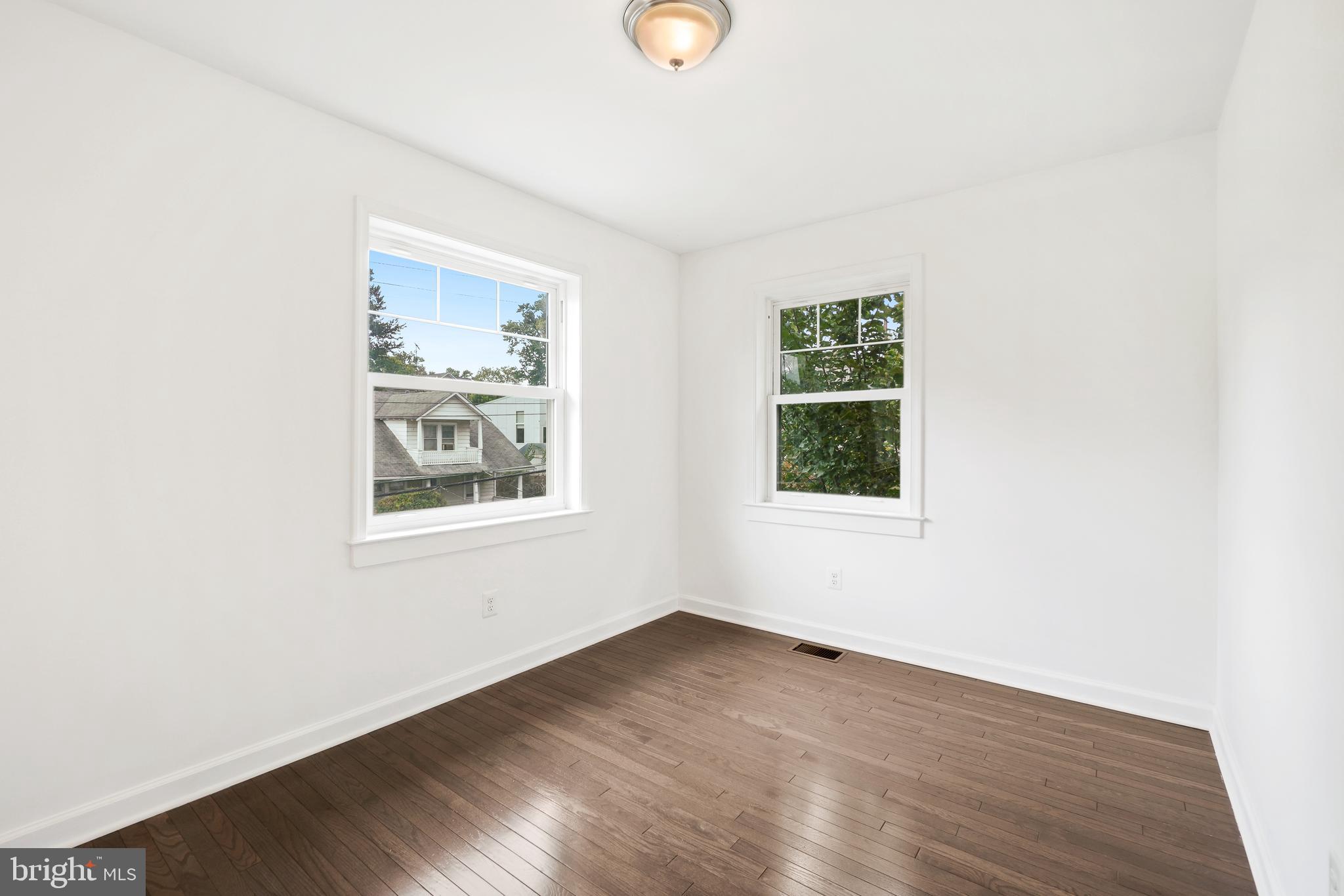 3114 19th Street South Arlington, VA 22204 - Photo 11 of 31 an empty room with wooden floor and windows