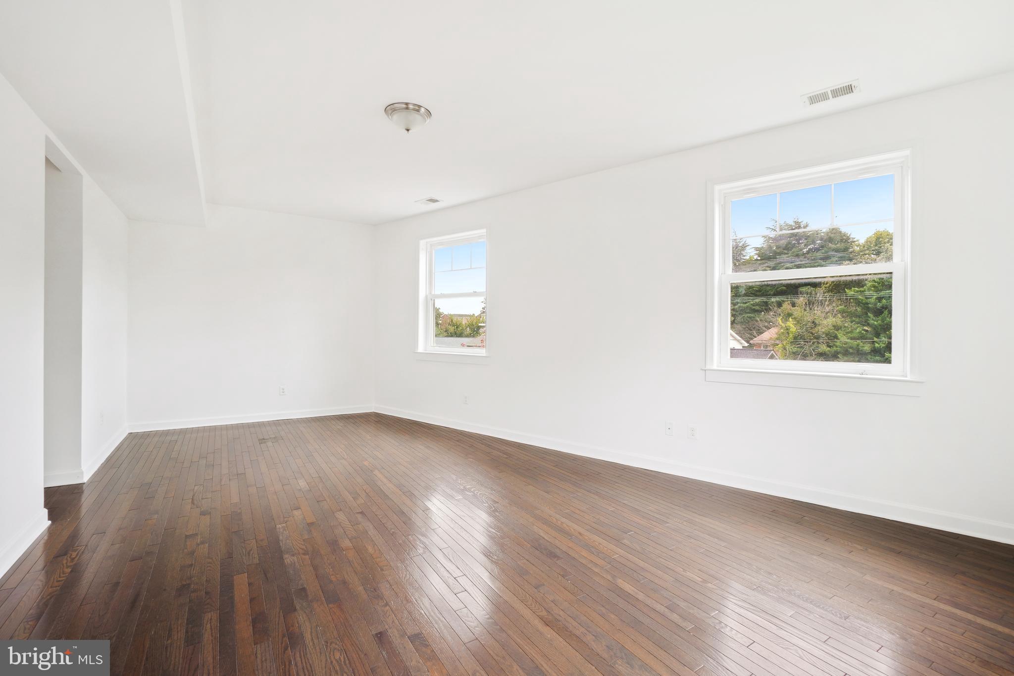 3114 19th Street South Arlington, VA 22204 - Photo 19 of 31 an empty room with wooden floor and windows