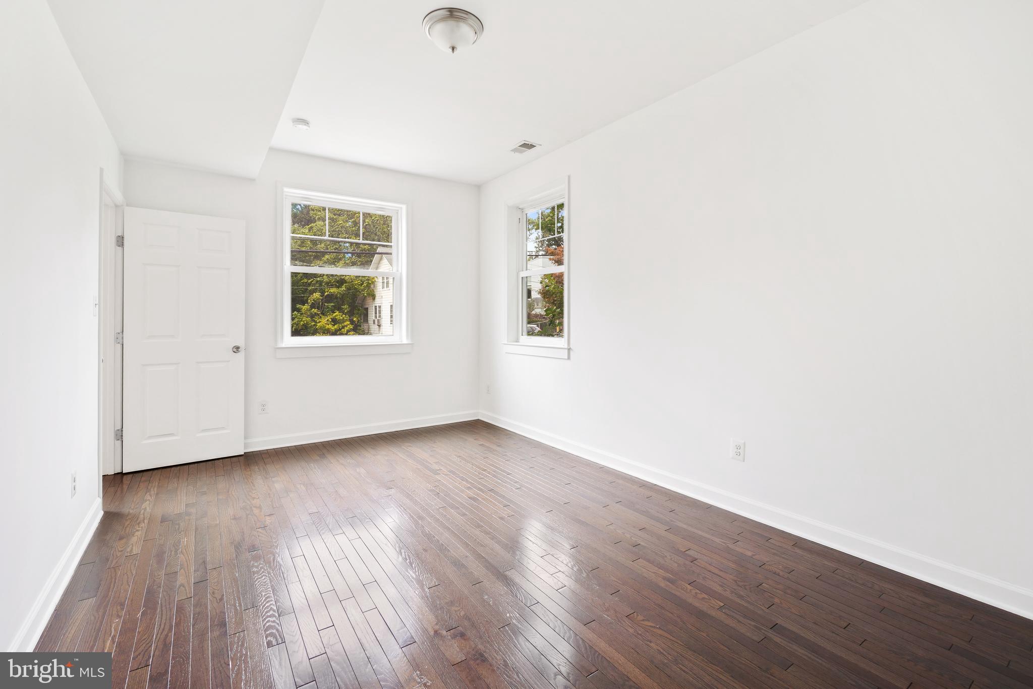 3114 19th Street South Arlington, VA 22204 - Photo 24 of 31 an empty room with wooden floor and windows