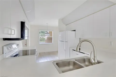 a close view of a sink a faucet and appliance in the kitchen