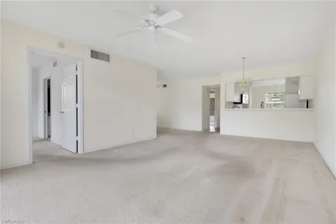 a view of a kitchen with a refrigerator and a sink
