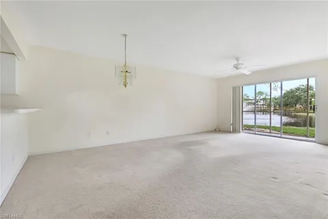 an empty room with windows and outdoor view