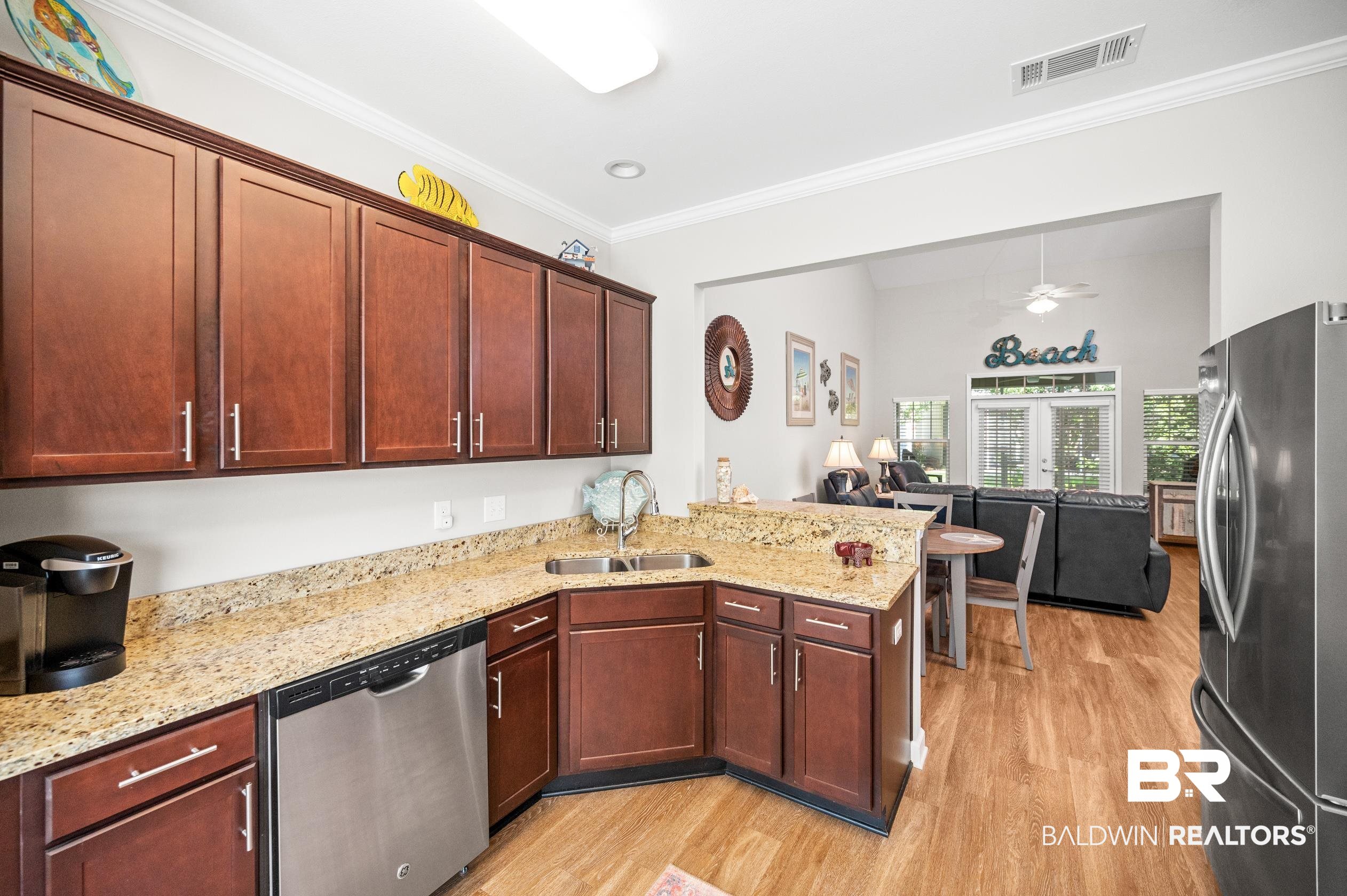 430 West Fort Morgan Road, Unit 1902 Gulf Shores, AL 36542 - Photo 16 of 59 Kitchen featuring ceiling fan, stainless steel appliances, light hardwood / wood-style floors, light stone countertops, and sink