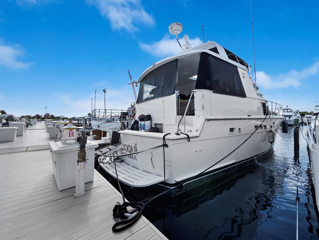 2800 Harbourside Drive, Unit E06 Longboat Key, FL 34228 - Photo 11 of 55 a roof deck with table and chairs a barbeque