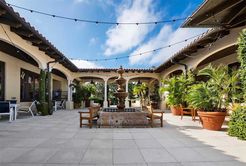 2800 Harbourside Drive, Unit E06 Longboat Key, FL 34228 - Photo 26 of 55 a view of a patio with table and chairs potted plants