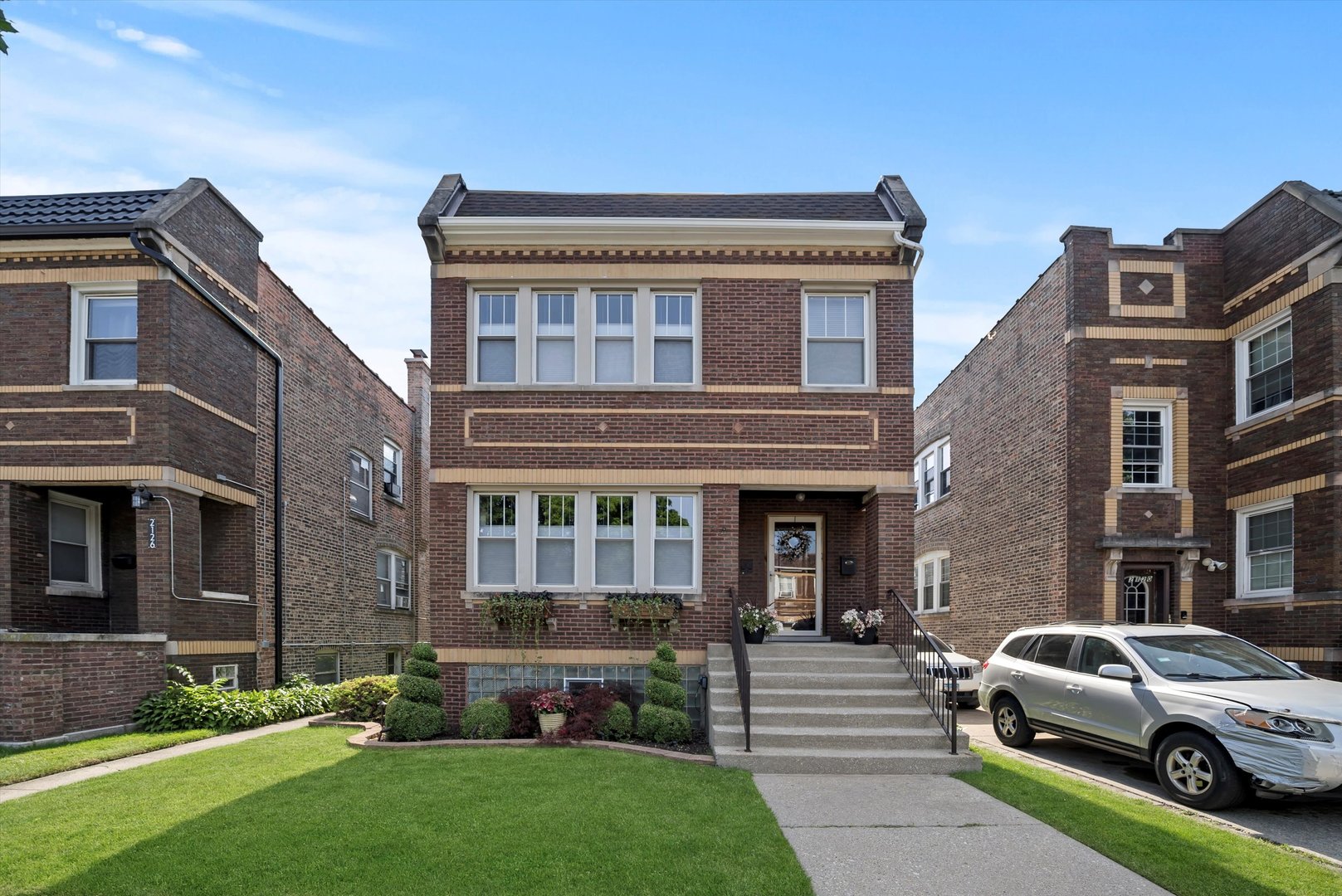 2124 Wesley Avenue Berwyn, IL 60402 - Photo 2 of 2 a view of a brick house with a yard next to a road