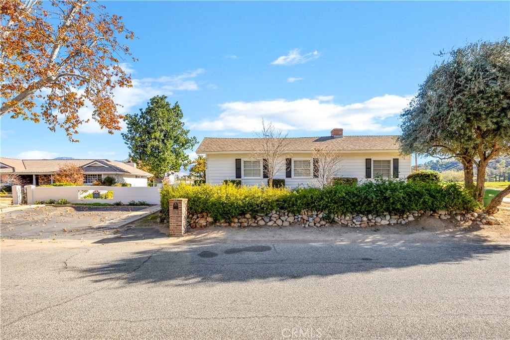27454 Hemet Street Hemet, CA 92544 - Photo 2 of 51 a front view of a house with a garden and pathway