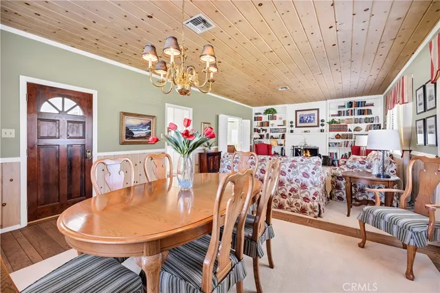 a view of a dining room with furniture and chandelier