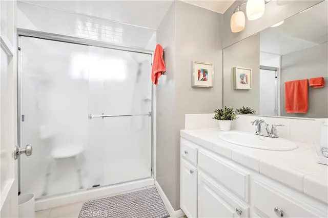 a bathroom with a sink vanity and a mirror