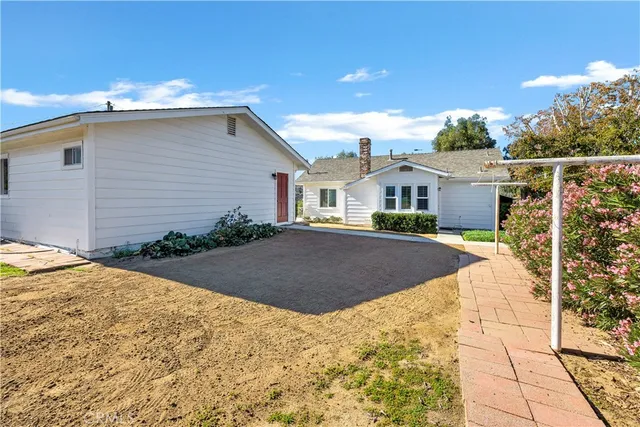 a view of house with yard and entertaining space