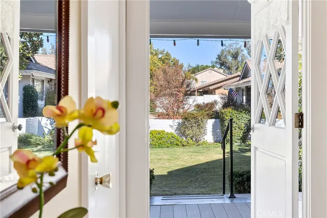 a vase of flowers sitting on a table with a potted plant