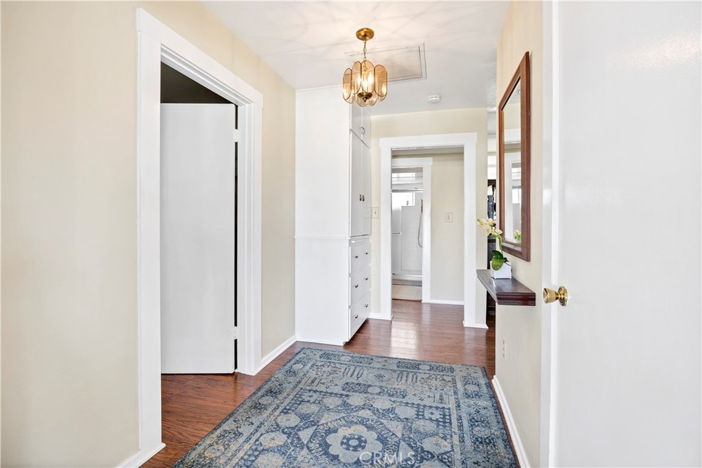 27454 Hemet Street Hemet, CA 92544 - Photo 9 of 51 view of a hallway with wooden floor and a bathroom