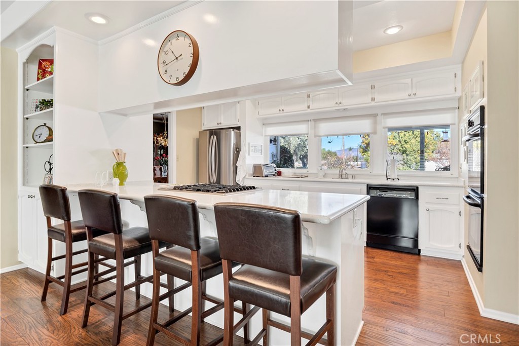 27454 Hemet Street Hemet, CA 92544 - Photo 10 of 51 a kitchen with a table chairs and a clock on the wall