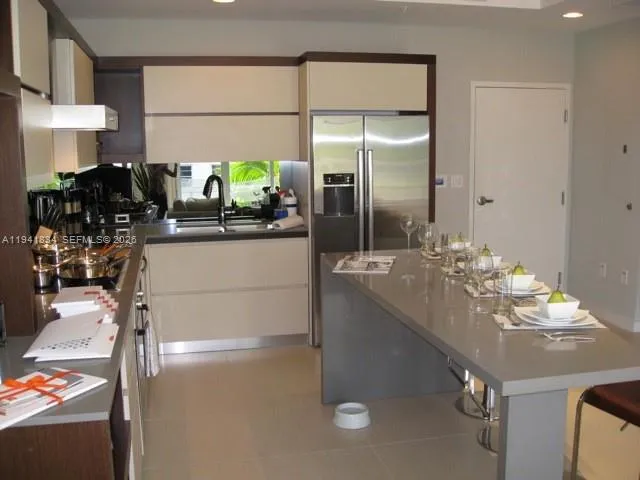 a kitchen with stainless steel appliances kitchen island granite countertop a sink and cabinets