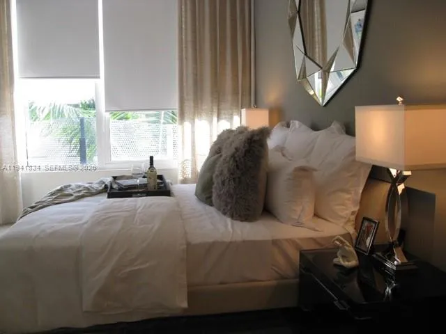 a bed sitting in a bedroom next to a window