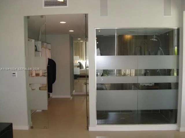 a bathroom with a glass shower door