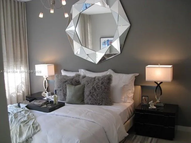 a bedroom with a bed and a lamp