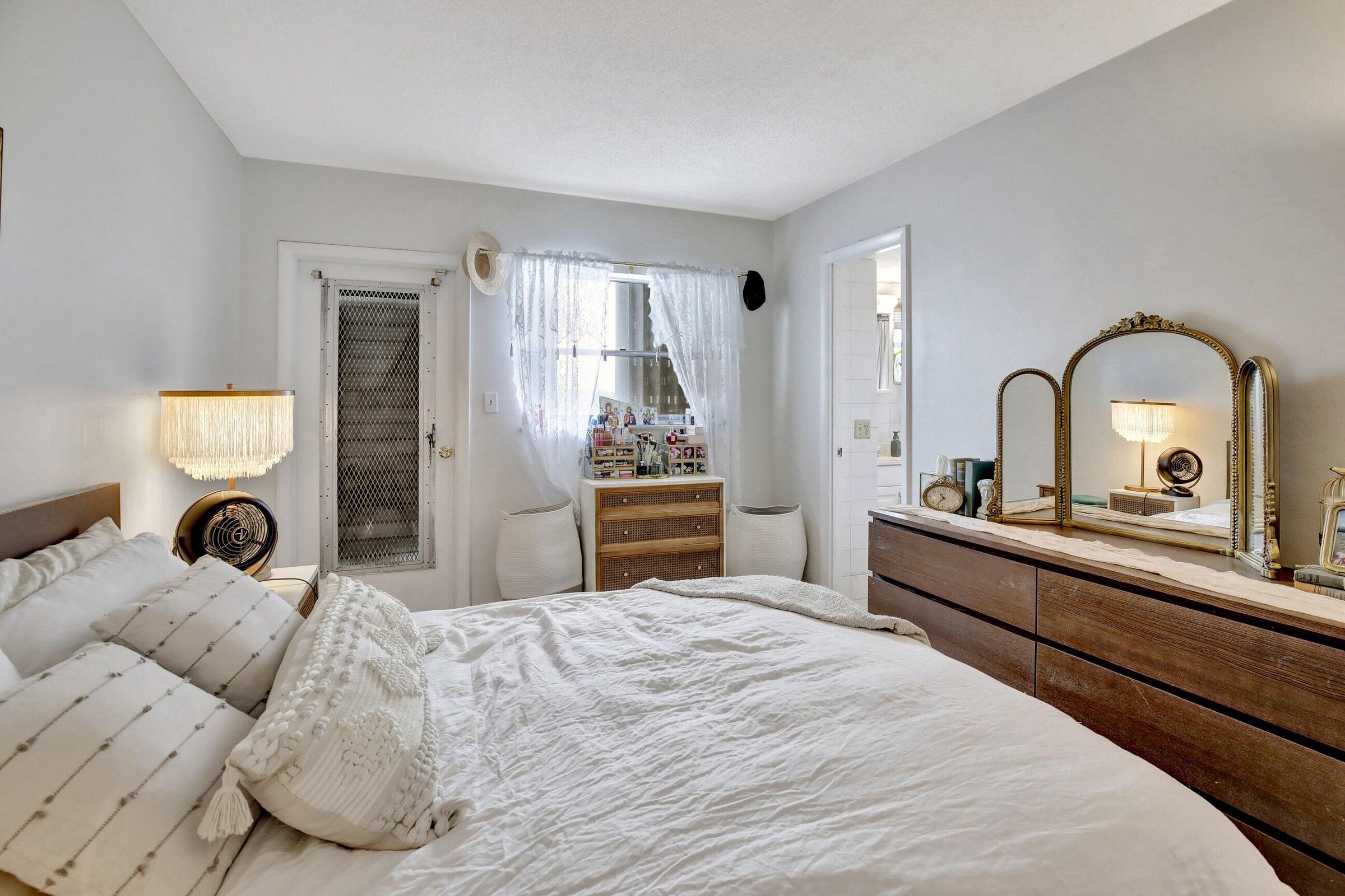 1750 Jefferson Street, Unit 305 Hollywood, FL 33020 - Photo 19 of 43 a bedroom with a bed and a dresser