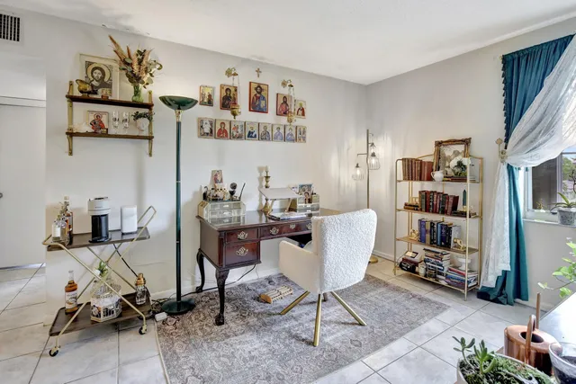 a living room with furniture a rug and a flat screen tv