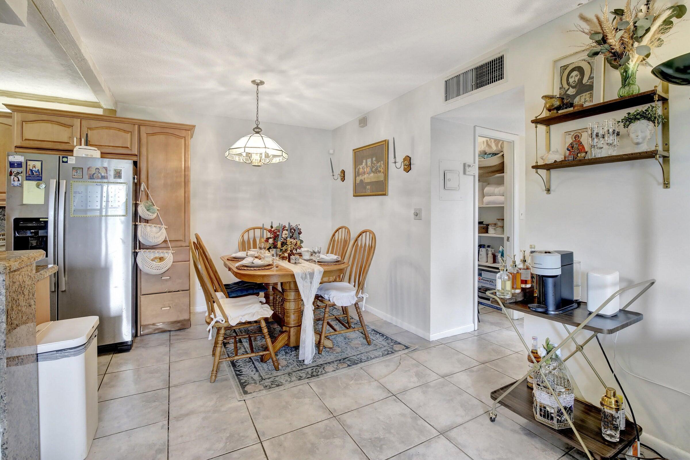 1750 Jefferson Street, Unit 305 Hollywood, FL 33020 - Photo 6 of 43 a view of a dining room with furniture and a chandelier