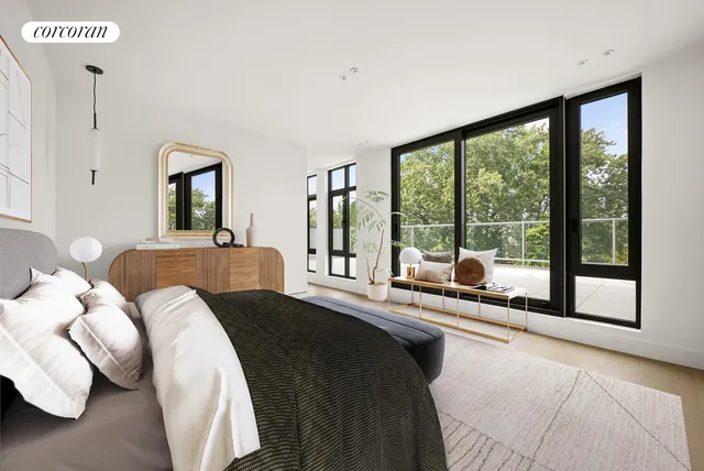 a bedroom with a bed and a large window