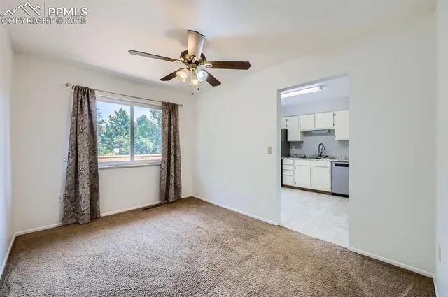 a view of a room with a ceiling fan and a window