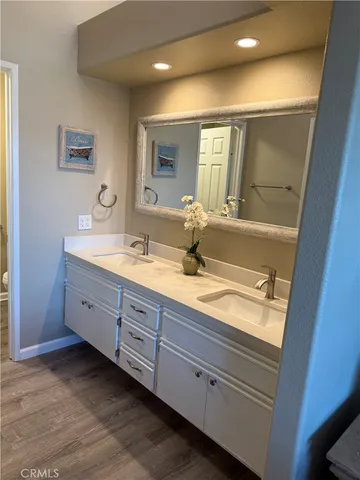 a bathroom with a toilet a sink and a mirror