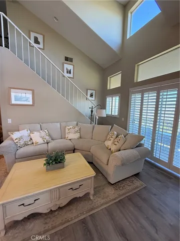 a living room with furniture window and wooden floor