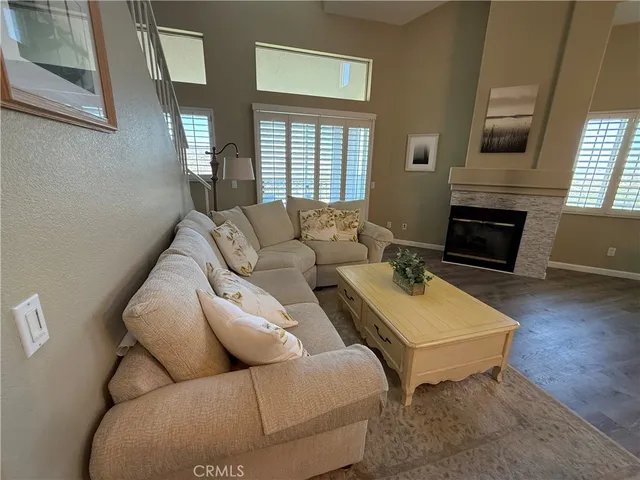 a living room with furniture fireplace and flat screen tv