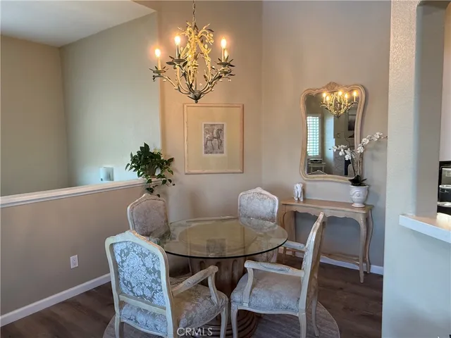 a dining room with furniture and chandelier