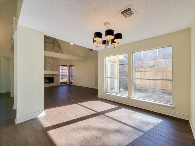 a view of a livingroom with wooden floor and a ceiling fan