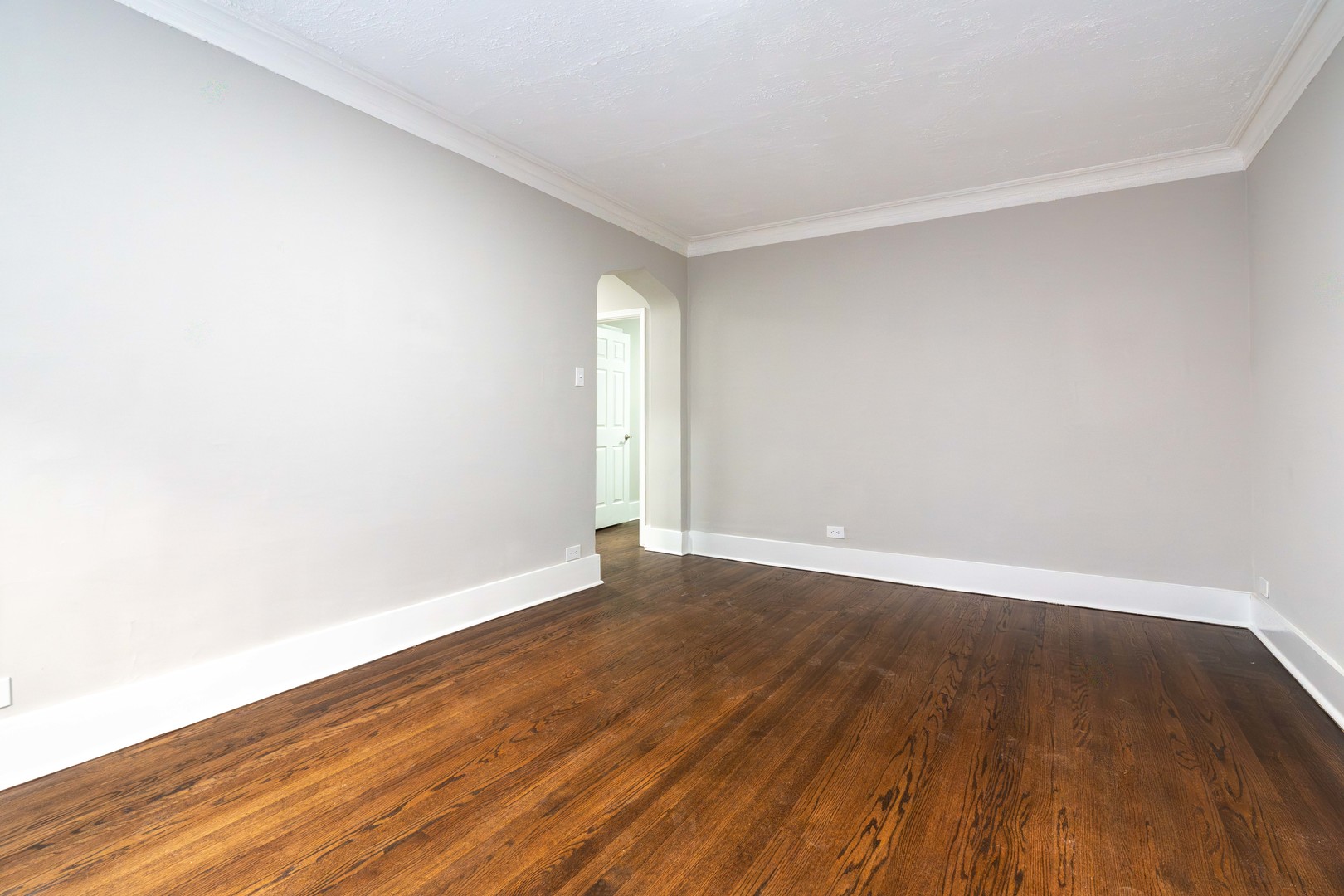 7420 North Damen Avenue, Unit 1F Chicago, IL 60645 - Photo 16 of 18 a view of an empty room with wooden floor