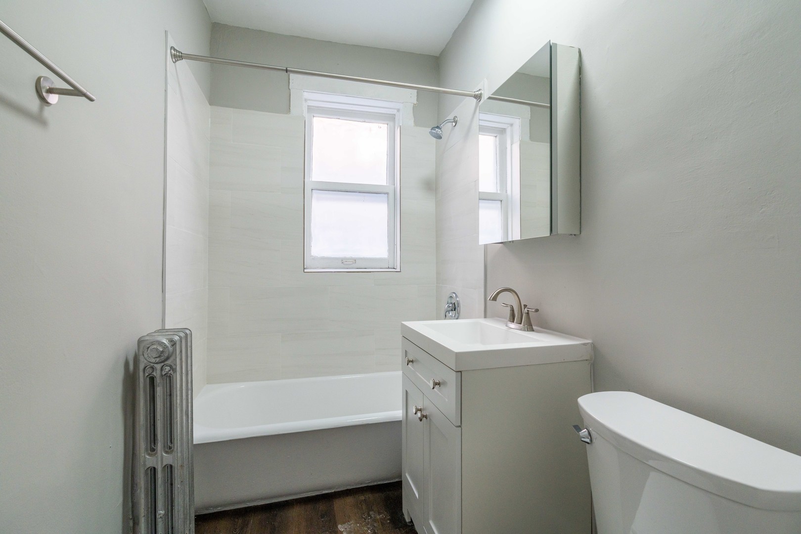 7420 North Damen Avenue, Unit 1F Chicago, IL 60645 - Photo 17 of 18 a bathroom with a sink toilet and tub