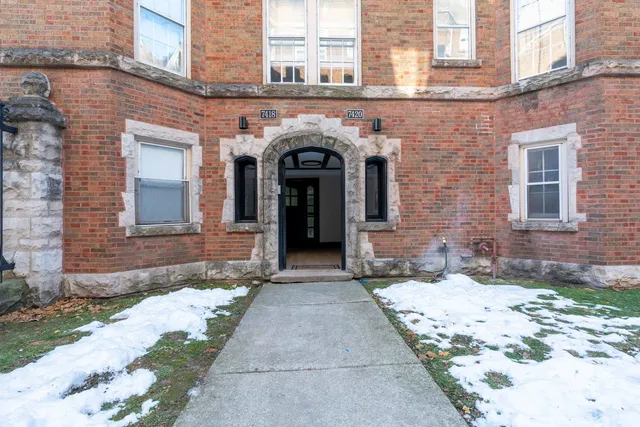 a view of a brick building with many windows