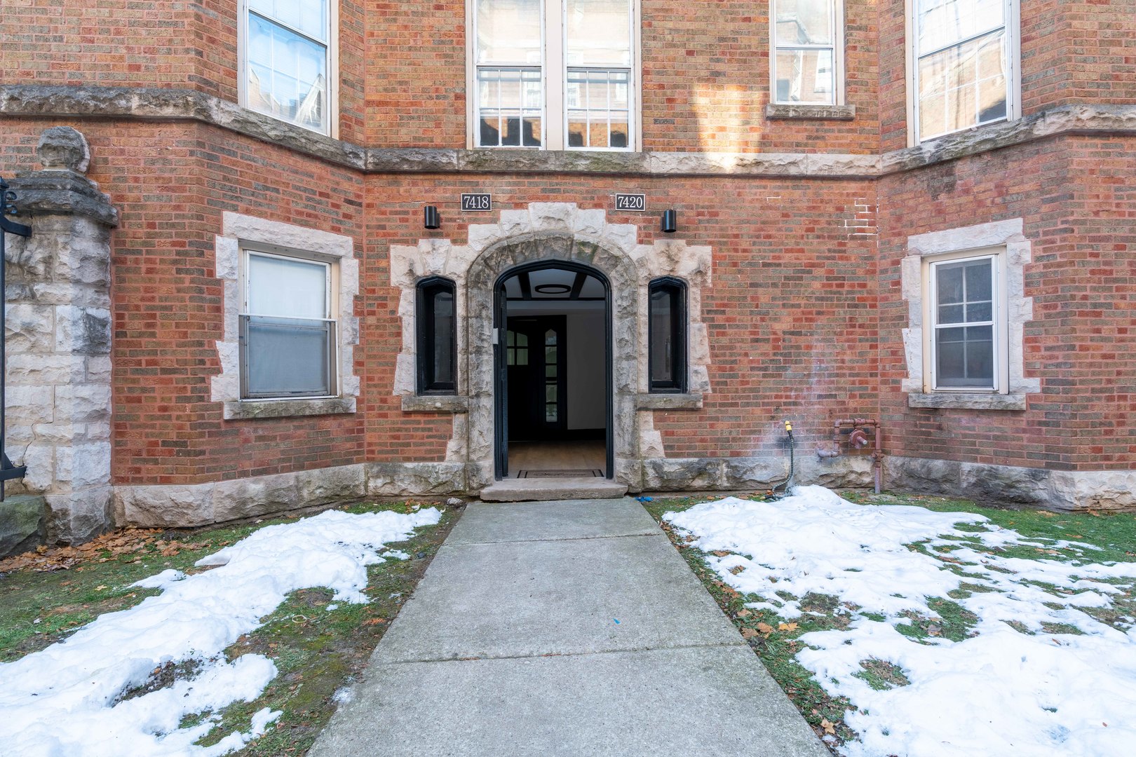 7420 North Damen Avenue, Unit 1F Chicago, IL 60645 - Photo 3 of 18 a view of a brick building with many windows