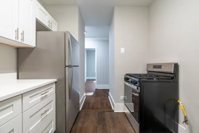 a kitchen with a refrigerator and a stove