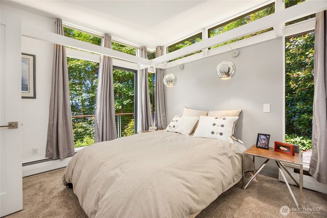 a large bed sitting in a bedroom next to a window