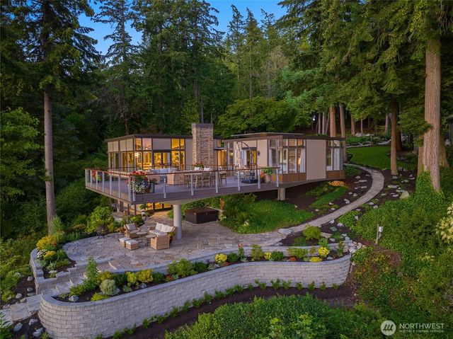 an aerial view of a house with a yard basket ball court and outdoor seating